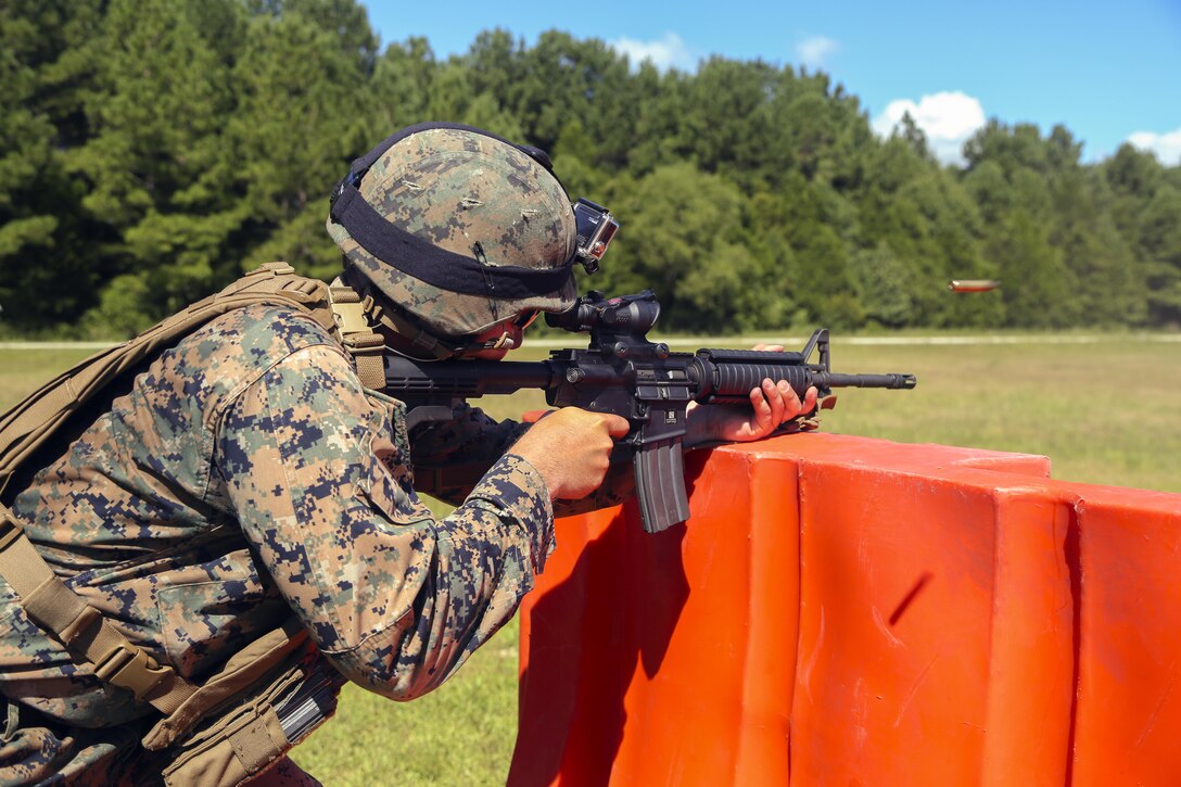 Sgt. James Jackson, Stone Bay alpha range line staff, fires an M4 service rifle at a target during a Combat Marksmanship Trainer Course were tested on coordinating a 3-gun shooting competition at Stone Bay on Marine Corps Base Camp Lejeune, Sept. 1. The competition enabled CMT students to become familiar with how to set up and run a range and range personnel were also able to hone their marksmanship skills. (U.S. Marine Corps photo by Cpl. Mark Watola /Released)