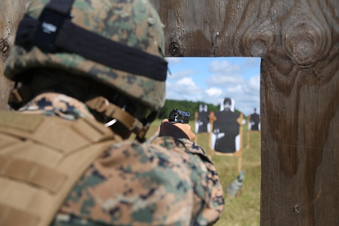 Sgt. James Jackson, Stone Bay alpha range line staff, fires an M9 service pistol at a target during a Combat Marksmanship Trainer Course were tested on coordinating a 3-gun shooting competition at Stone Bay on Marine Corps Base Camp Lejeune, Sept. 1. The competition enabled CMT students to become familiar with how to set up and run a range and range personnel were also able to hone their marksmanship skills. (U.S. Marine Corps photo by Cpl. Mark Watola /Released)