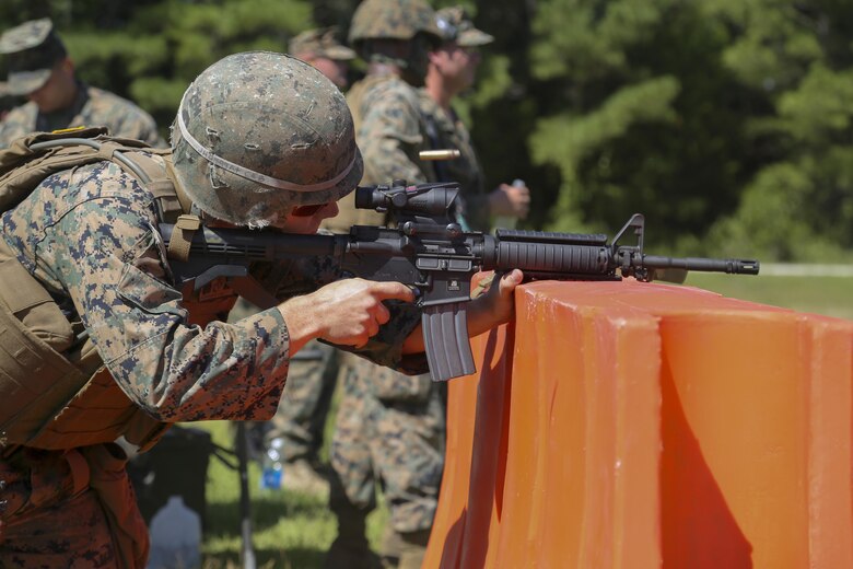 Cpl. Joshua Hodel, Stone Bay target shed noncommissioned officer in charge, fires an M4 service rifle at a target during a Combat Marksmanship Trainer Course were tested on coordinating a 3-gun shooting competition at Stone Bay on Marine Corps Base Camp Lejeune, Sept. 1. The competition enabled CMT students to become familiar with how to set up and run a range and range personnel were also able to hone their marksmanship skills. (U.S. Marine Corps photo by Cpl. Mark Watola /Released)