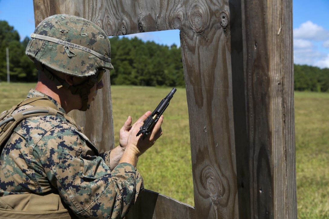 Cpl. Joshua Hodel, Stone Bay target shed noncommissioned officer in charge, conducts a speed reload with the M9 service pistol Combat Marksmanship Trainer Course were tested on coordinating a 3-gun shooting competition at Stone Bay on Marine Corps Base Camp Lejeune, Sept. 1. The competition enabled CMT students to become familiar with how to set up and run a range and range personnel were also able to hone their marksmanship skills. (U.S. Marine Corps photo by Cpl. Mark Watola /Released)