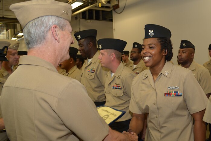 Engineman 1st Class Staci Allen shakes hands with Vice Adm. Tom Moore prior to receiving her Navy Afloat Maintenance Training Strategy (NAMTS) Certificate of Completion. Allen is a Sailor attached to Southeast Regional Maintenance Center (SERMC) in Mayport, Fla.