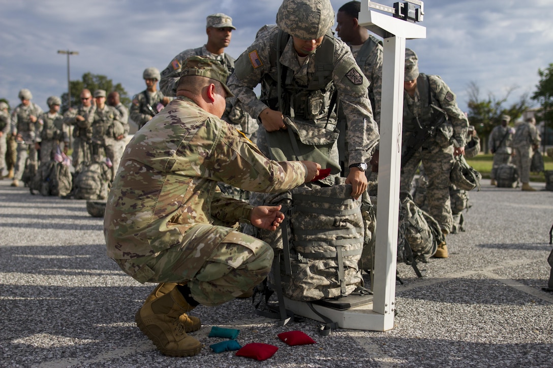 U.S. Army Reserve Soldiers assigned to the 200th Military Police Command weight their ruck sacks prior to a ruck march on Fort Meade, Md., Sept. 11, 2016. The Soldiers marched five miles with 35-pound ruck sacks. Before starting the march, the unit conducted a moment of silence in honor of those lost during 9/11 and Soldiers shared their personal memories of the attacks. (U.S. Army Reserve photo by Spc. Stephanie Ramirez)