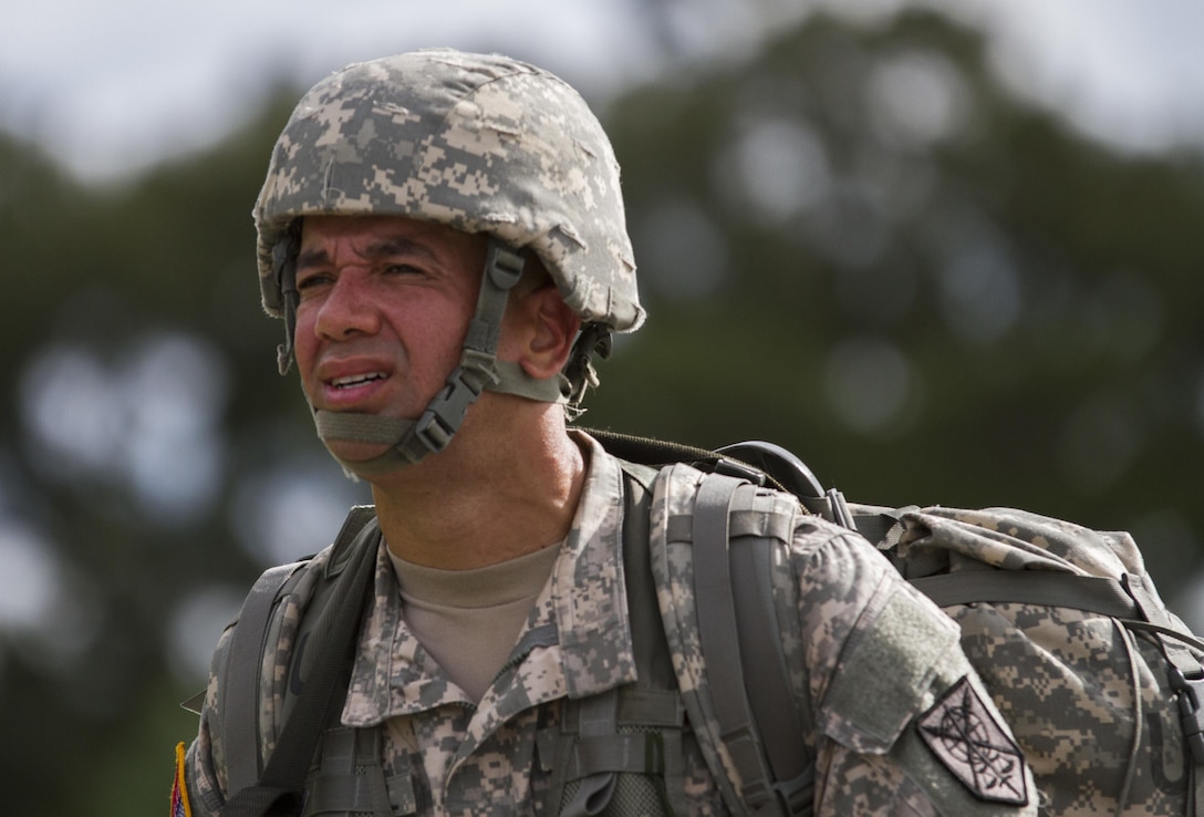 Sgt. John C. Carvajal, a human resource specialist in the U.S. Army Reserve assigned to the 200th Military Police Command, walks during a ruck march on Fort Meade, Md., Sept. 11, 2016. Before starting the march, the unit conducted a moment of silence in honor of those lost during 9/11 and Soldiers shared their personal memories of the attacks. (U.S. Army Reserve photo by Spc. Stephanie Ramirez)