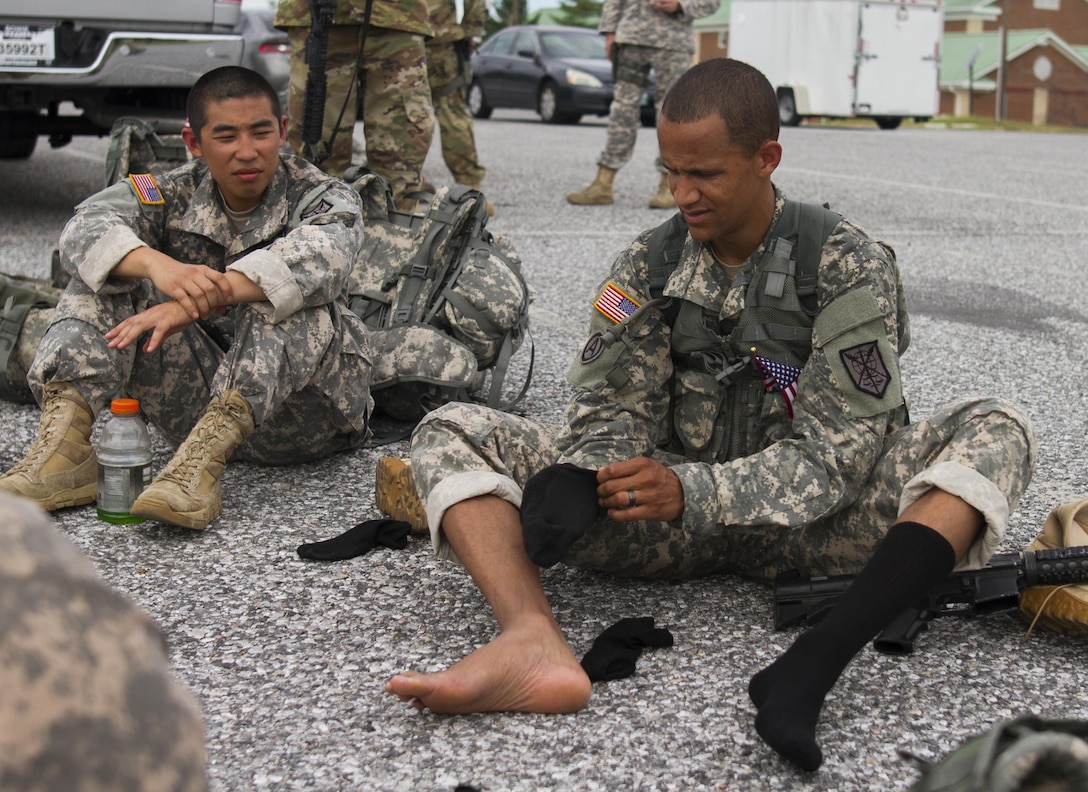 U.S. Army Reserve Soldiers assigned to the 200th Military Police Command rest after a ruck march on Fort Meade, Md., Sept. 11, 2016. The Soldiers marched five miles with 35-pound ruck sacks. Before starting the march, the unit conducted a moment of silence in honor of those lost during 9/11 and Soldiers shared their personal memories of the attacks. (U.S. Army Reserve photo by Spc. Stephanie Ramirez)