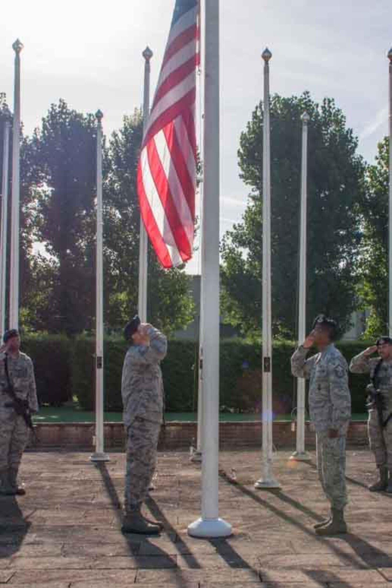 Members of the 307th Security Forces Squadron place the flag at half staff during a ceremony at Royal Air Force Base Fairford, England, Sept. 11, 2016.  The ceremony was held in honor of those who lost their lives on September 11, 2001 as a result of the attacks against the United States.  These members are deployed to RAF Base Fairford in support of Exercise Ample Strike 2016, a Czech Republic led, 18-nation live exercise.  (U.S. Air Force photo by 1st Lt. Monique Roux/Released)