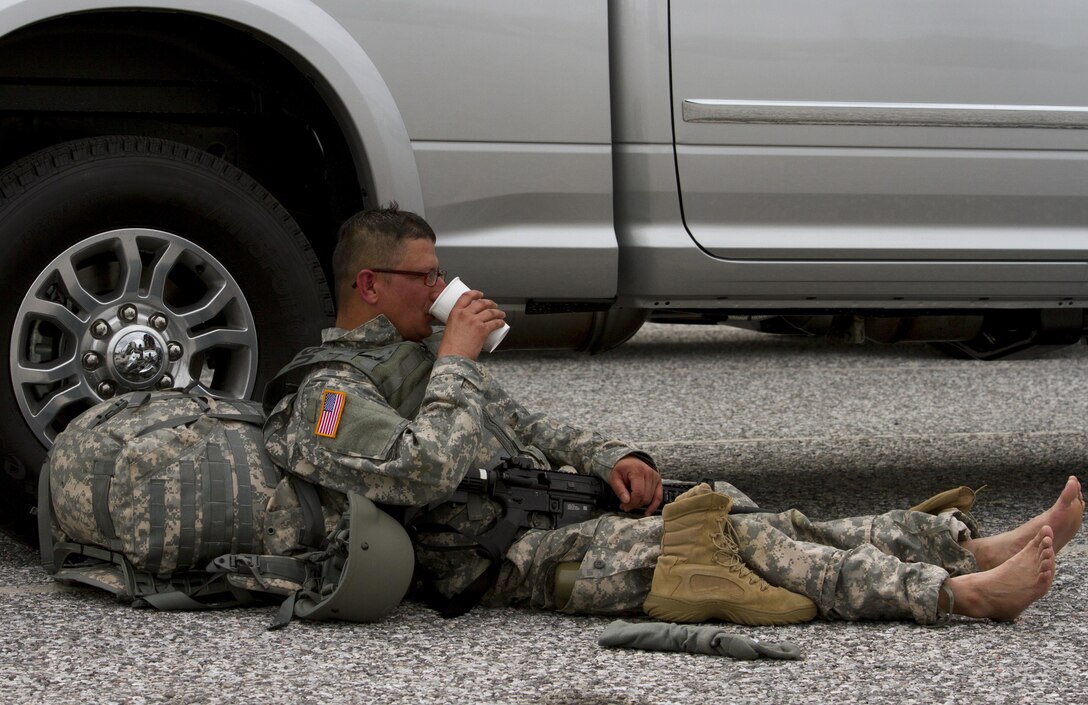 Sgt. Narayan Poudyal, a U.S. Army Reserve paralegal with the 200th Military Police Command, relaxes and hydrates after finishing a ruck march on Fort Meade, Md., Sept. 11. The march was five miles long and each of the Soldiers were required to carry a ruck that weighed at least 35 pounds.  (U.S. Army Reserve photo by Sgt. Audrey Hayes)