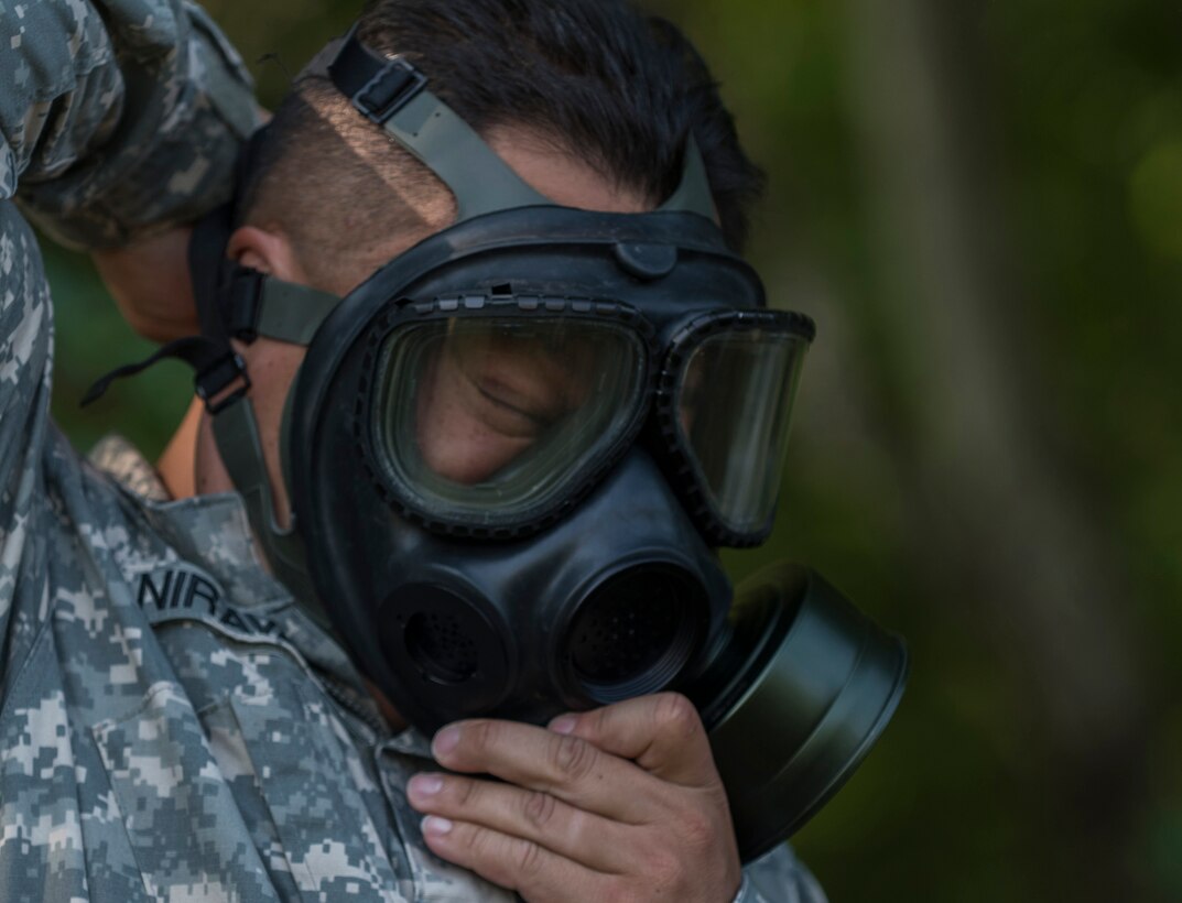 U.S. Army Reserve Sgt. Mesa Niravanh, intelligence analyst assigned to the 200th Military Police Command, puts on a gas mask as part of an exercise during Army Warrior Tasks training at Laudrick Creek Military Reservation, Md., Sept. 10. The training, held during September's Battle Assembly, consisted of stations covering Chemical, Biological, Radiological, and Nuclear attack;  9-Line Medical Evacuation; search of a suspect; individual movement techniques and others. (U.S. Army Reserve photo by Staff Sgt. Shejal Pulivarti/released)
