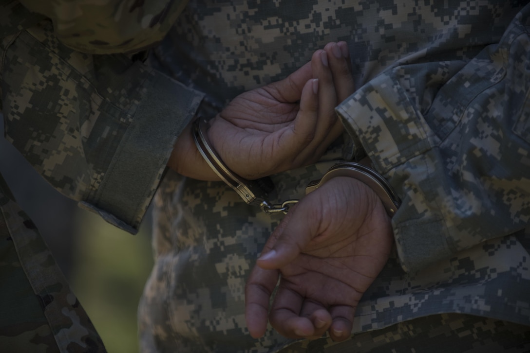 A U.S. Army Reserve Soldier, assigned to 200th Military Police Command, role playing as a suspect is handcuffed during the search and seizure of a suspect station during Army Warrior Tasks training at Laudrick Creek Military Reservation, Md., Sept. 10. The training, held during September's Battle Assembly, consisted of stations covering Chemical, Biological, Radiological, and Nuclear attack;  9-Line Medical Evacuation; search of a suspect; individual movement techniques and others. (U.S. Army Reserve photo by Staff Sgt. Shejal Pulivarti/released)