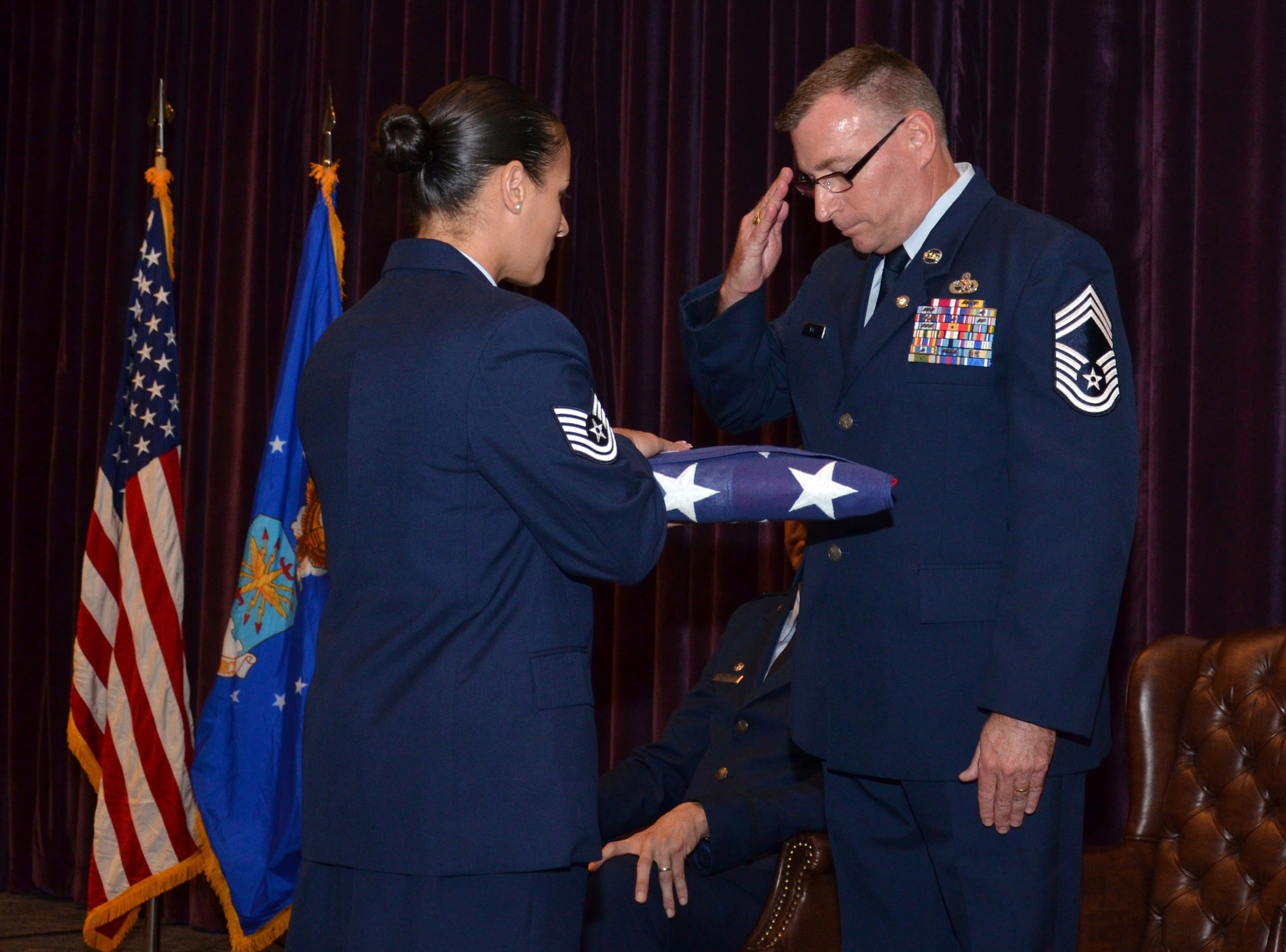 Chief Master Sgt. Phil Roe salutes the American flag during his retirement ceremony Sept. 10, 2016 at Patrick Air Force Base, Fla. Roe served in the 920th Rescue Wing and its predecessor squadron for 26 of his 36 years in the Air Force. (U.S. Air Force photo by 1st Lt. Anna-Marie Wyant)