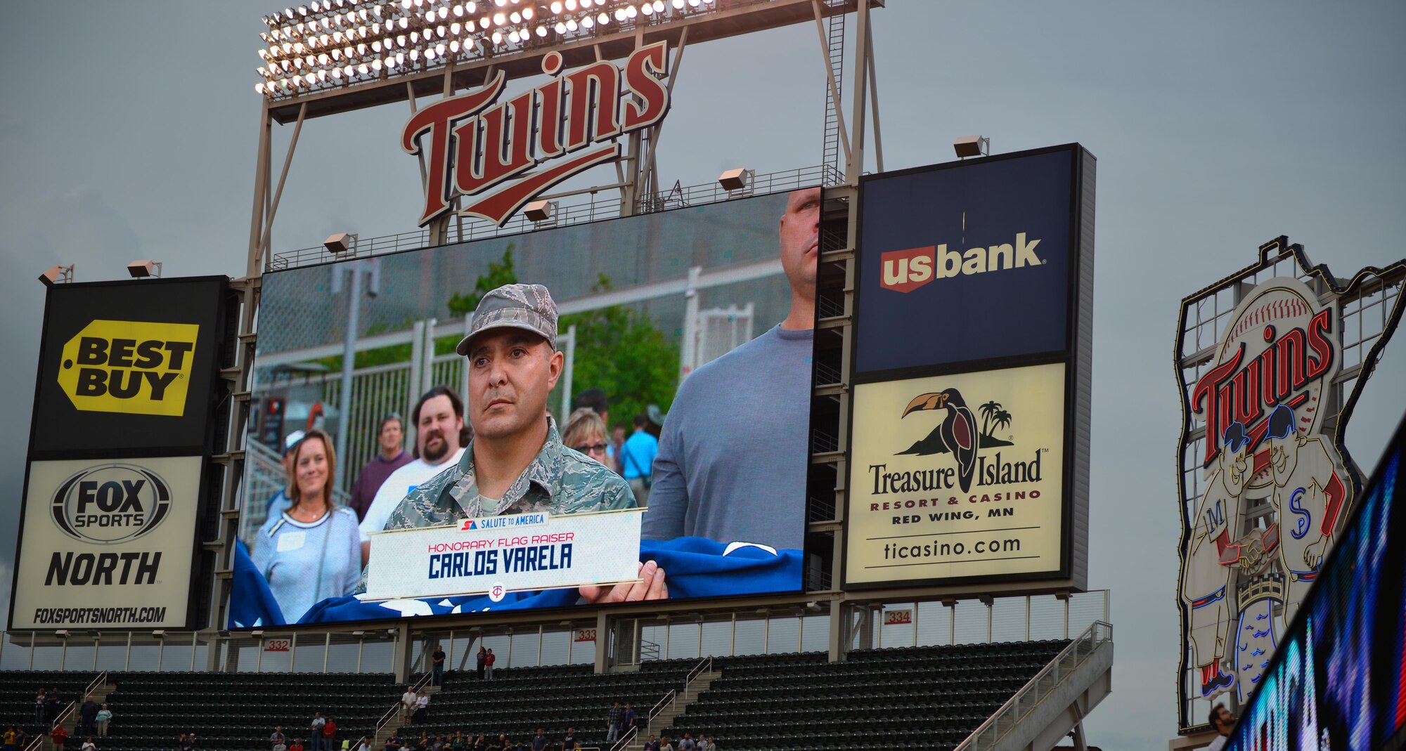 Master Sgt. Carlos Varela raises the flag at the Minnesota Twins game Sept. 9. Varela and other members of the 934th Airlift Wing Civil Engineer Squadron were honored for their recent work while deployed to Southwest Asia.  