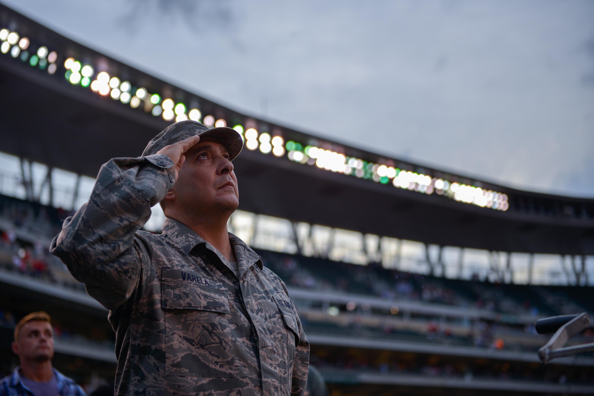 Master Sgt. Carlos Varela raises the flag at the Minnesota Twins game Sept. 9. Varela and other members of the 934th Airlift Wing Civil Engineer Squadron were honored for their recent work while deployed to Southwest Asia.  