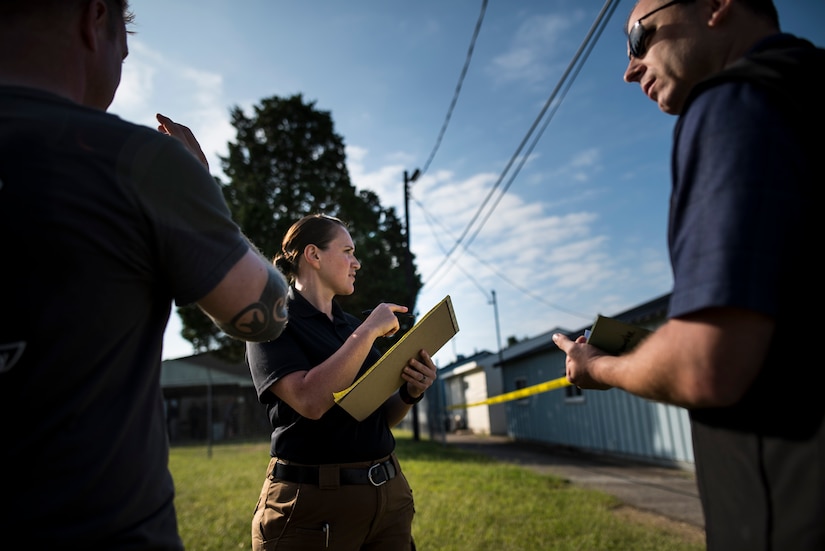 U.S. Army special agent Nikki Drury, with the Fort Meade Criminal Investigation Division Office in Maryland, points to a crime scene during Capital Shield 2016 at Fort Belvoir, Virginia, Sept. 13. Approximately 15 U.S. Army Reserve criminal investigative special agents trained alongside 25 active duty agents for the first time in a joint training exercise known as Capital Shield, focusing on crime scene processing, evidence management and hostage negotiations, Sept. 13-15. The reserve Soldiers participating in this year's Capital Shield are agents from the 733rd Military Police Battalion (Criminal Investigation Division), headquartered in Fort Gillem, Georgia, which reports to the 200th Military Police Command. The active duty agents belong to various offices across the Washington CID Battalion, headquartered at Fort Myer, Virginia. (U.S. Army Reserve photo by Master Sgt. Michel Sauret)