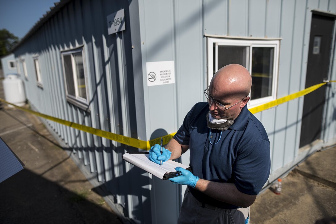 U.S. Army special agent Briggon Bobb, with the Aberdeen Proving Ground Criminal Investigation Office in Maryland, takes notes before entering a crime scene during Capital Shield 2016 at Fort Belvoir, Virginia, Sept. 13. Approximately 15 U.S. Army Reserve criminal investigative special agents trained alongside 25 active duty agents for the first time in a joint training exercise known as Capital Shield, focusing on crime scene processing, evidence management and hostage negotiations, held Sept. 13-15. The reserve Soldiers participating in this year's Capital Shield are agents from the 733rd Military Police Battalion (Criminal Investigation Division), headquartered in Fort Gillem, Georgia, which reports to the 200th Military Police Command. The active duty agents belong to various offices across the Washington CID Battalion, headquartered at Fort Myer, Virginia. (U.S. Army Reserve photo by Master Sgt. Michel Sauret)