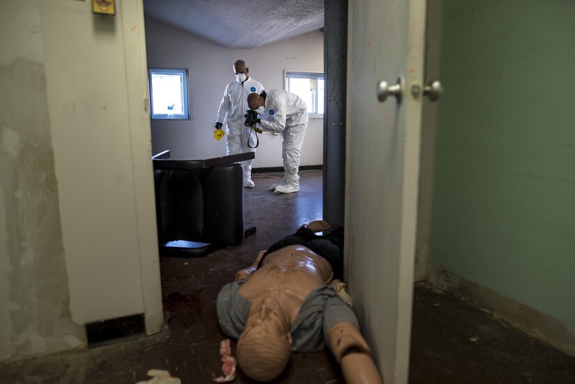 Two U.S. Army special agents process a crime scene during Capital Shield 2016 at Fort Belvoir, Virginia, Sept. 13. Approximately 15 U.S. Army Reserve criminal investigative special agents trained alongside 25 active duty agents for the first time in a joint training exercise known as Capital Shield, focusing on crime scene processing, evidence management and hostage negotiations, held Sept. 13-15. The reserve Soldiers participating in this year's Capital Shield are agents from the 733rd Military Police Battalion (Criminal Investigation Division), headquartered in Fort Gillem, Georgia, which reports to the 200th Military Police Command. The active duty agents belong to various offices across the Washington CID Battalion, headquartered at Fort Myer, Virginia. (U.S. Army Reserve photo by Master Sgt. Michel Sauret)