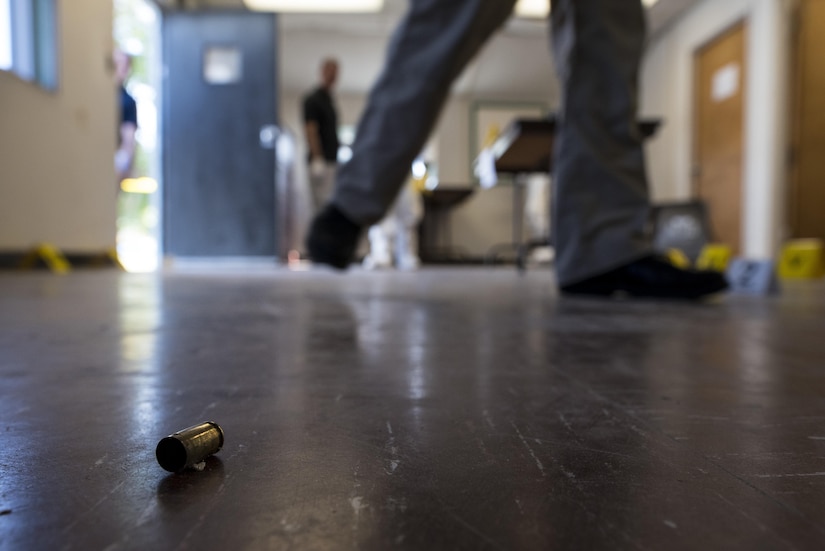 A shell casing lays on the floor of a crime scene during Capital Shield 2016 at Fort Belvoir, Virginia, Sept. 13. Approximately 15 U.S. Army Reserve criminal investigative special agents trained alongside 25 active duty agents for the first time in a joint training exercise known as Capital Shield, focusing on crime scene processing, evidence management and hostage negotiations, held Sept. 13-15. The reserve Soldiers participating in this year's Capital Shield are agents from the 733rd Military Police Battalion (Criminal Investigation Division), headquartered in Fort Gillem, Georgia, which reports to the 200th Military Police Command. The active duty agents belong to various offices across the Washington CID Battalion, headquartered at Fort Myer, Virginia. (U.S. Army Reserve photo by Master Sgt. Michel Sauret)