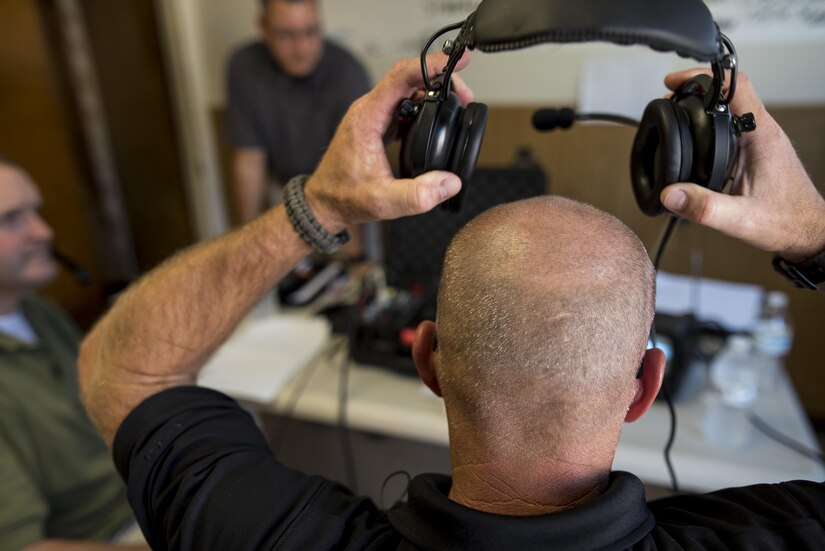 U.S. Army Reserve special agent Craig Powers, with the 383rd Military Police Detachment, Lakeland, Florida, takes off his headset after talking with a hostage taker during Capital Shield 2016 at Fort Belvoir, Virginia, Sept. 13. Approximately 15 U.S. Army Reserve criminal investigative special agents trained alongside 25 active duty agents for the first time in a joint training exercise known as Capital Shield, focusing on crime scene processing, evidence management and hostage negotiations, held Sept. 13-15. The reserve Soldiers participating in this year's Capital Shield are agents from the 733rd Military Police Battalion (Criminal Investigation Division), headquartered in Fort Gillem, Georgia, which reports to the 200th Military Police Command. The active duty agents belong to various offices across the Washington CID Battalion, headquartered at Fort Myer, Virginia. (U.S. Army Reserve photo by Master Sgt. Michel Sauret)