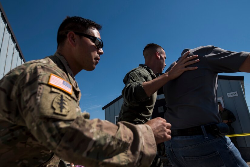 Staff Sgt. Daniel Khan, U.S. Army Soldier with the 55th Explosive Ordnance Division Company, and a member of a Special Reaction Team, extract a hostage from a scene during Capital Shield 2016 at Fort Belvoir, Virginia, Sept. 14. Approximately 15 U.S. Army Reserve criminal investigative special agents trained alongside 25 active duty agents for the first time in a joint training exercise known as Capital Shield, focusing on crime scene processing, evidence management and hostage negotiations, held Sept. 13-15. The reserve Soldiers participating in this year's Capital Shield are agents from the 733rd Military Police Battalion (Criminal Investigation Division), headquartered in Fort Gillem, Georgia, which reports to the 200th Military Police Command. The active duty agents belong to various offices across the Washington CID Battalion, headquartered at Fort Myer, Virginia. (U.S. Army Reserve photo by Master Sgt. Michel Sauret)