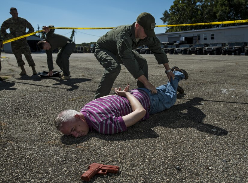 A member of the Special Reaction Team, Military District of Washington, inspects 1st Sgt. Donald Rackley, senior enlisted leader of the 733rd Military Police Battalion (Criminal Investigation Division), who pretended to be a hostage taker during Capital Shield 2016 at Fort Belvoir, Virginia, Sept. 14. Approximately 15 U.S. Army Reserve criminal investigative special agents trained alongside 25 active duty agents for the first time in a joint training exercise known as Capital Shield, focusing on crime scene processing, evidence management and hostage negotiations, held Sept. 13-15. The reserve Soldiers participating in this year's Capital Shield are agents from the 733rd MP Bn. (CID), headquartered in Fort Gillem, Georgia, which reports to the 200th Military Police Command. The active duty agents belong to various offices across the Washington CID Battalion, headquartered at Fort Myer, Virginia. (U.S. Army Reserve photo by Master Sgt. Michel Sauret)