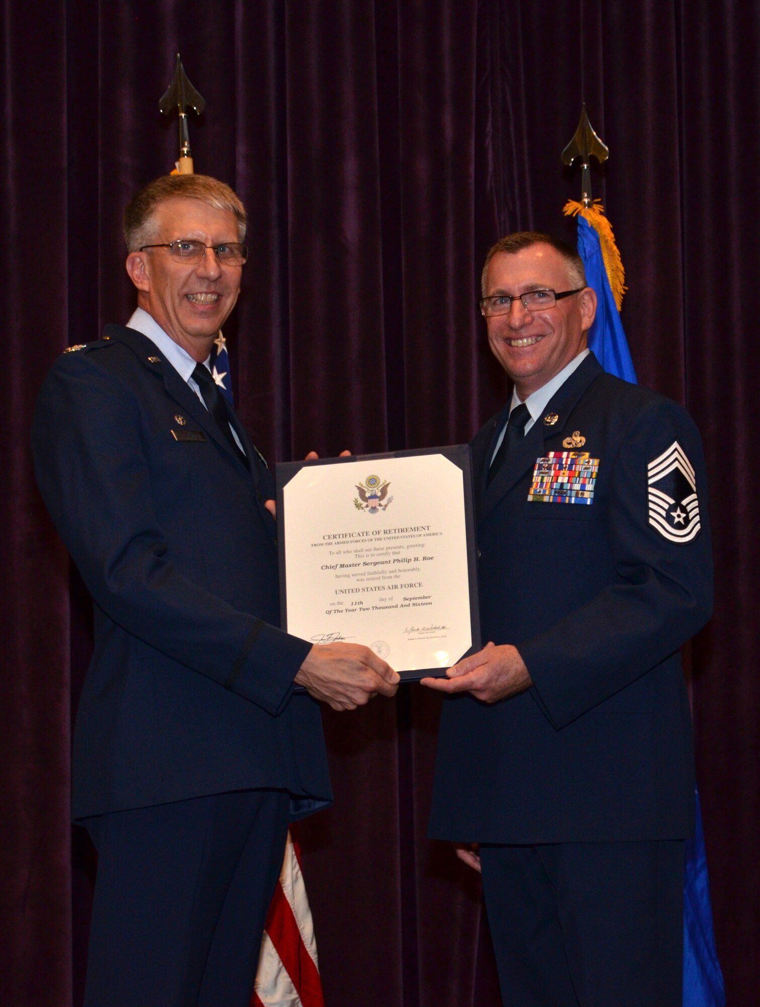 Col. Jeffrey Macrander, 920th Rescue Wing commander (left), presents a certificate of retirement to Chief Master Sgt. Philip Roe, 920th Aircraft Maintenance Squadron chief enlisted manager and superintendent, Sept. 10, 2016 at Patrick Air Force Base, Fla. Roe served in the Air Force for 36 years, the majority of which was spent with the 920th Rescue Wing. (U.S. Air Force photo by 1st Lt. Anna-Marie Wyant)