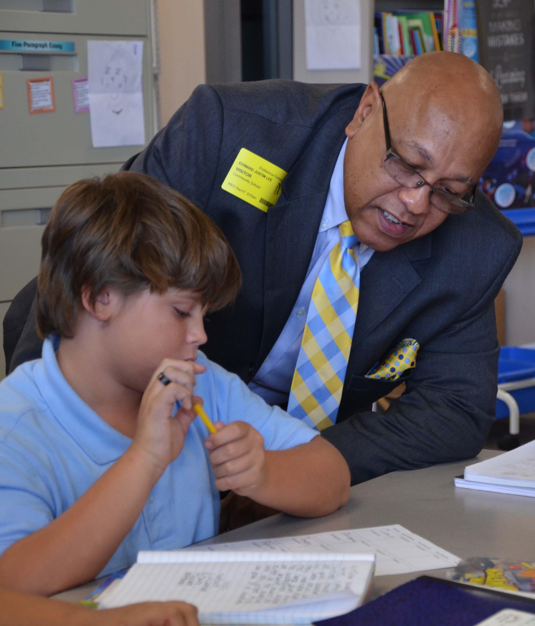 Ed Lee, program coordinator for historically black colleges, universities and minority-serving institutions, looks over classwork with Clayton Hovik, a 5th grader in Stephanie Lay’s science class at Endeavour Elementary School in Cocoa Fla., Sept. 7, 2016.  Lee visited the Title I facility to observe the partnership between the school and the Air Force Technical Applications Center, Patrick AFB, Fla.  (U.S. Air Force photo by Susan A. Romano)

