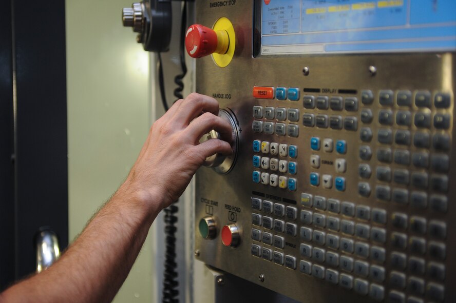 Staff Sgt. Jared Henden, 2nd Maintenance Squadron Fabrication Flight aircraft metals technology journeyman, sets up the Computer Numerical Controlled machine to build a battery tie down bracket at Barksdale Air Force Base, La., Sept. 13, 2016. The CNC is programmed plans to build different parts so Airmen don’t have to create them manually. (U.S. Air Force photo/Airman 1st Class Stuart Bright)