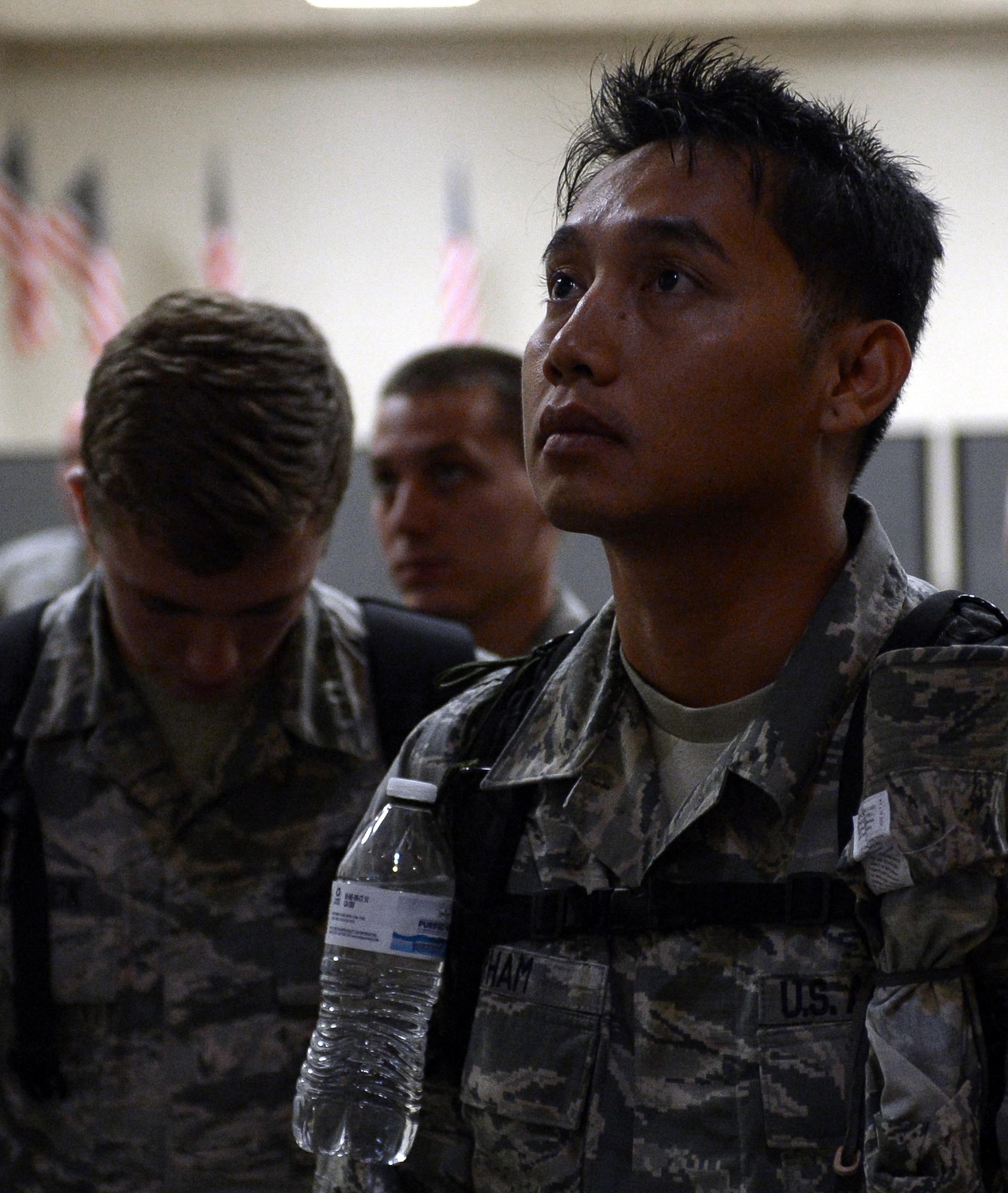 Tech. Sgt. Phong Pham, 2nd Operations Support Squadron, listens to a briefing before deploying from Barksdale Air Force Base, La., Sept. 10, 2016. More than 350 Airmen from Barksdale deployed to Al Udeid Air Base, Qatar, from Sept. 6-10 in support of Operation Inherent Resolve. The mission of OIR is to defeat the terrorist organization DA’ESH, commonly referred to as ISIS, to increase regional stability. (U.S. Air Force photo/Senior Airman Curt Beach)