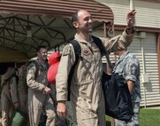 Capt. John Blankenship, 11th Bomb Squadron pilot, waves goodbye as he prepares to board a plane to deploy from Barksdale Air Force Base, La., Sept. 10, 2016. More than 350 Airmen from Barksdale deployed to Al Udeid Air Base, Qatar, from Sept. 6-10 in support of Operation Inherent Resolve. The team is a composite force with representation from the 11th BS, 20th Bomb Squadron, 96th Bomb Squadron and the 2nd Operations Support Squadron. While deployed, they will be combined under the 96th Expeditionary Bomb Squadron. (U.S. Air Force photo/Senior Airman Curt Beach)