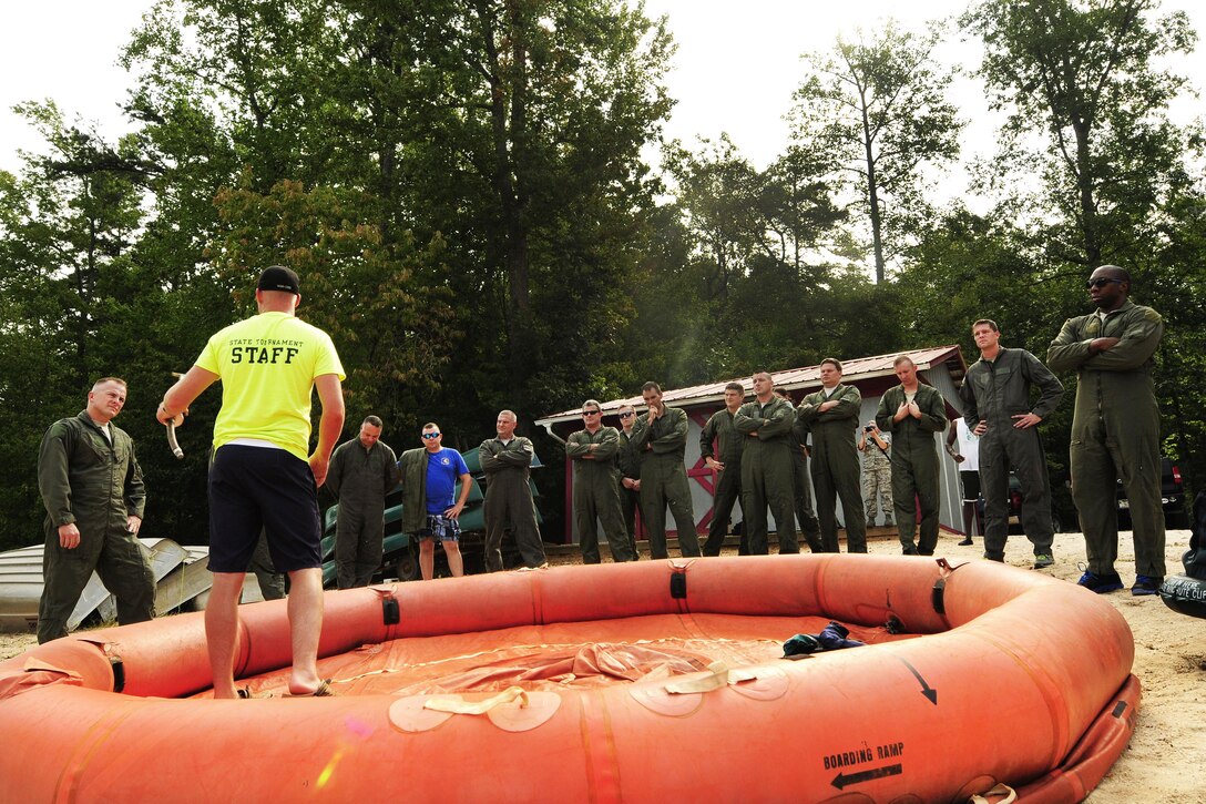 Air Force Master Sgt. William Puckett, left, instructs C-130 Hercules aircrews on the use and operation of a 20-man life raft during a water survival refresher course at Camp John J. Barnhardt, New London, N.C., Sept. 10, 2016. Puckett is an instructor assigned to the 145th Operations Support Squadron. The airmen are pilots and crew chiefs assigned to the 145th Operations Group. Hands-on familiarity with all of the emergency equipment kept on the C-130 is essential to build muscle memory in times of crisis. Air National Guard photo by Staff Sgt. Julianne M. Showalter