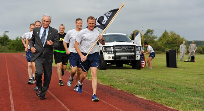U.S. Air Force Lt. Col. (Ret.) Barry Bridger, 43rd Tactical Fighter Squadron F-4 Phantom pilot, left, runs alongside Airmen and Soldiers from Joint Base Langley-Eustis during the first lap of a 24-hour run in honor of Prisoner of War/Missing in Action Recognition Day at JBLE, Va., Sept. 15, 2016. The 24-hour run ended the next morning with a POW/MIA closing ceremony, which the entire base was invited to attend. (U.S. Air Force photo by Tech. Sgt. Austin May)