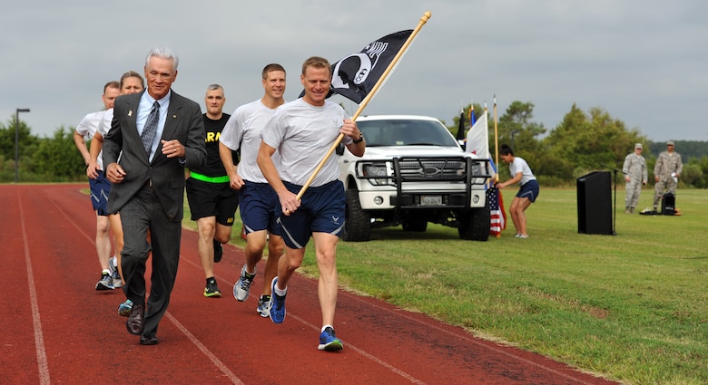 U.S. Air Force Lt. Col. (Ret.) Barry Bridger, 43rd Tactical Fighter Squadron F-4 Phantom pilot, left, runs alongside Airmen and Soldiers from Joint Base Langley-Eustis during the first lap of a 24-hour run in honor of Prisoner of War/Missing in Action Recognition Day at JBLE, Va., Sept. 15, 2016. The 24-hour run ended the next morning with a POW/MIA closing ceremony, which the entire base was invited to attend. (U.S. Air Force photo by Tech. Sgt. Austin May)