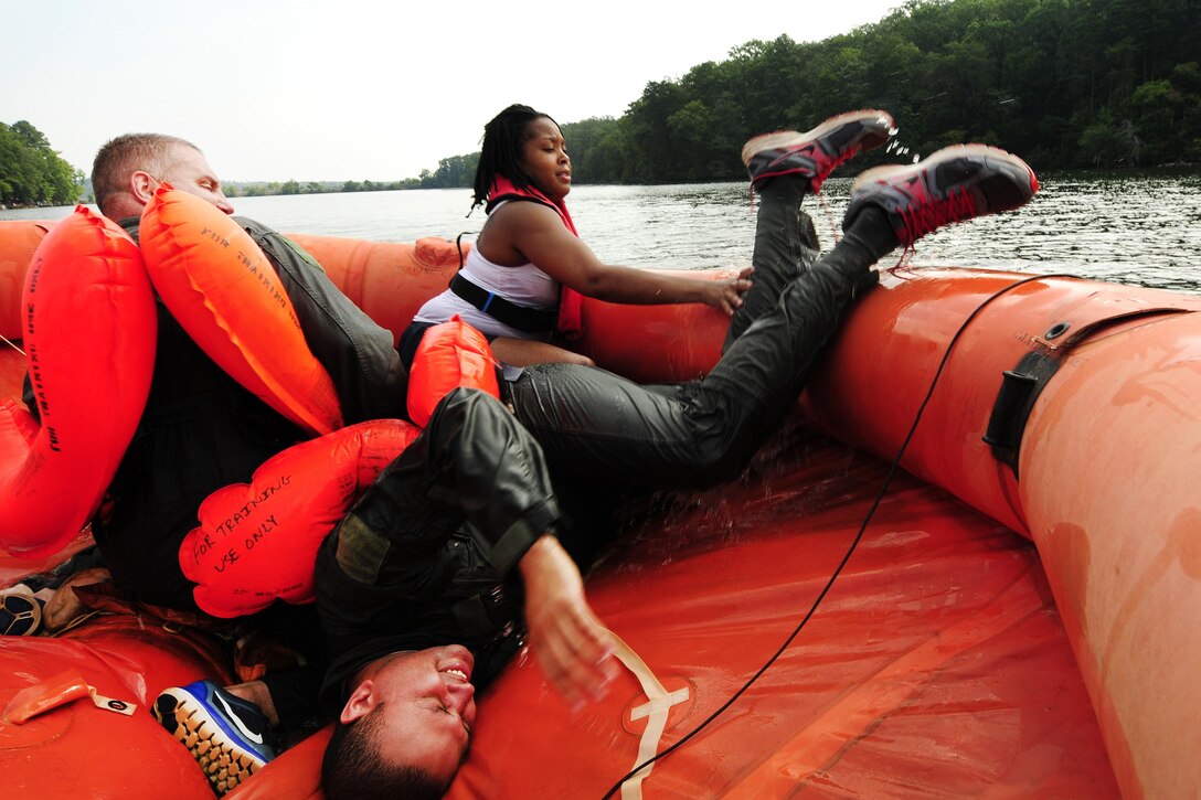 Air Force Tech. Sgt. Jason Hutton crawls into a 20-man life raft during a water survival refresher course at Camp John J. Barnhardt, New London, N.C., Sept. 10, 2016. Hutton is a C-13 Hercules crew chief assigned to the 156th Airlift Squadron. Air National Guard photo by Staff Sgt. Julianne M. Showalter