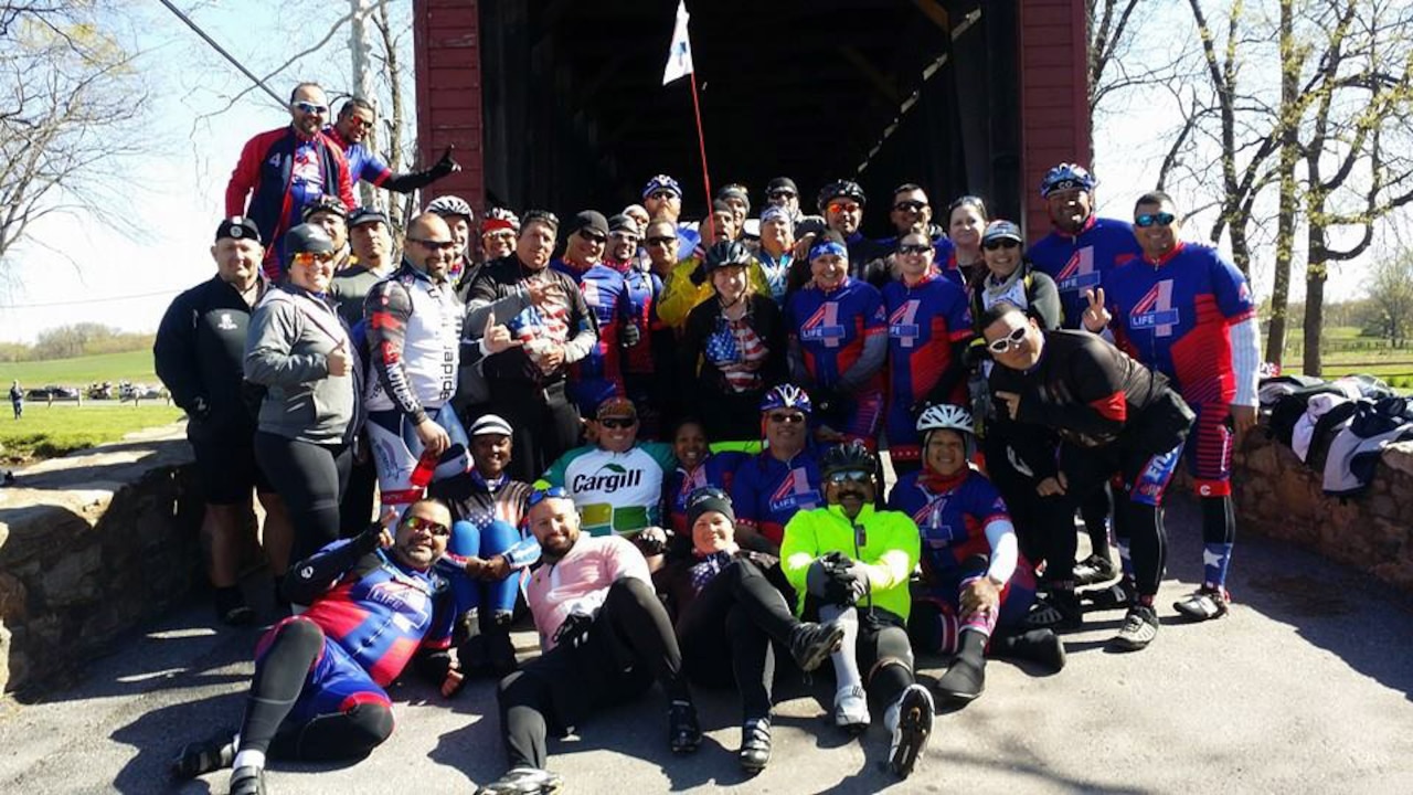 The Warriors4Life team stops to take a group photo during their two-day, 110-mile Face of America bike ride from Arlington, Va., to Gettysburg, Pa., April 25-26, 2015. More than 150 disabled veteran cyclists and 600 able-bodied cyclists participated in the annual World T.E.A.M. Sports event. Throughout the event, each cyclist helped each other along the course. Courtesy photo