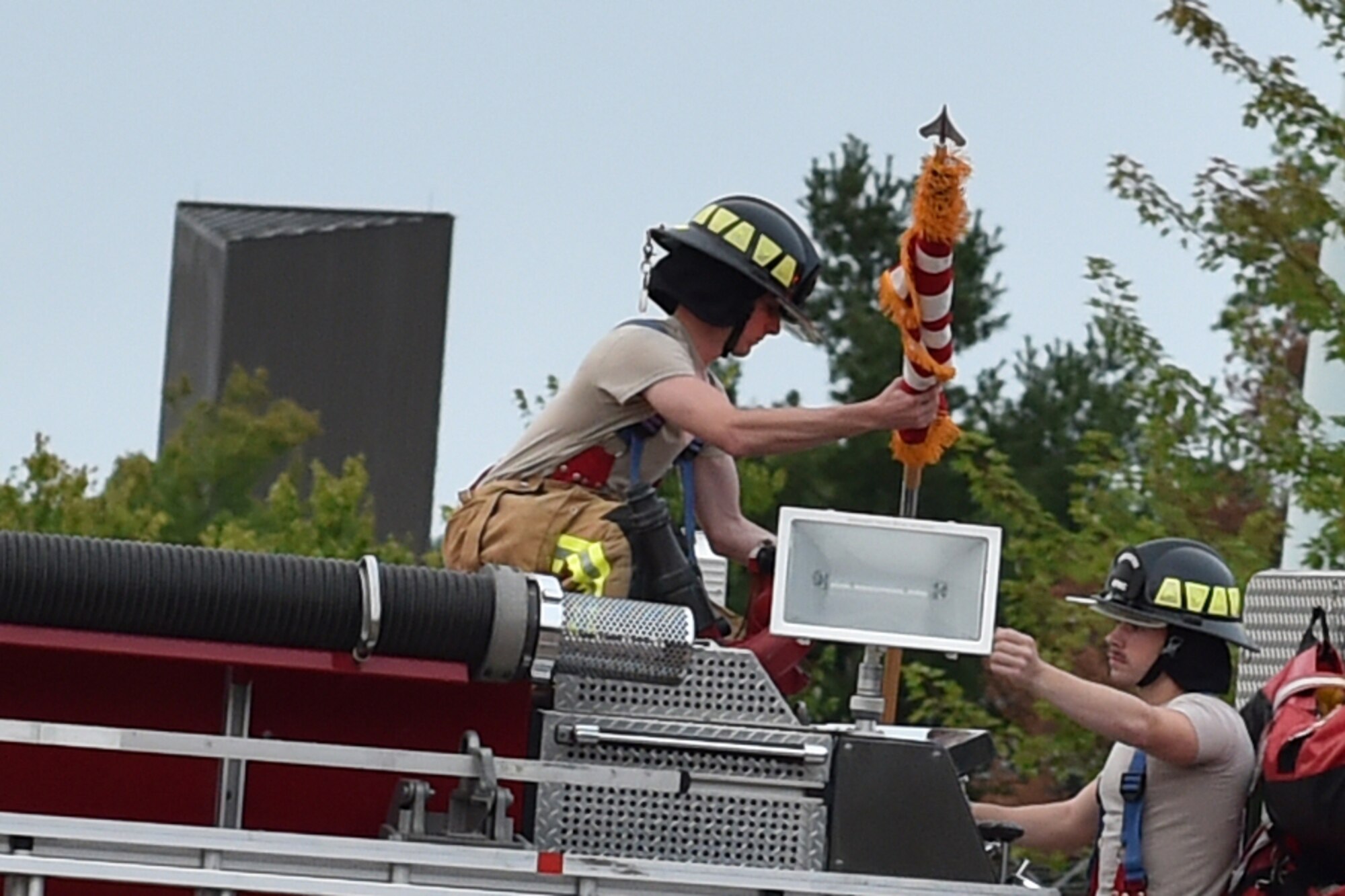 Members of the 910th Civil Engineer Squadron fire department pass the flag during a 9/11 remembrance ceremony here, Sept. 11, 2016. (U.S. Air Force photo/Tech. Sgt. James Brock)