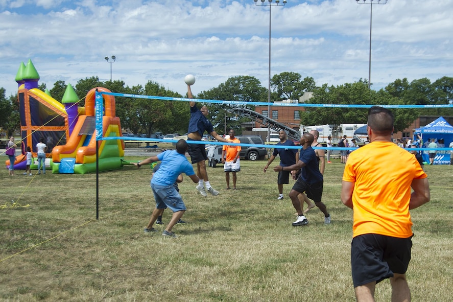 Members of the 459th Air Refueling Wing face-off in a match of volleyball during Family Day at Joint Base Andrews, Maryland, Sunday, Sept. 11, 2016. The annual event featured food, sumo wrestling, volleyball, dunk tank, children’s obstacle course, softball jump castle, photo booth and much more. (U.S. Air Force photo/Staff Sgt. Kat Justen)