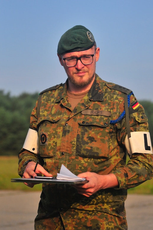 Capt. Konrad Fuchs, company commander of the 4th Company, 33rd Mechanized Infantry Batallion, gives the morning instructions to his unit while on the Puma Live-Fire Range in Bergen, Germany Sept. 31.  (U.S. Army Reserve photo by Capt. Xeriqua Garfinkel, Released)