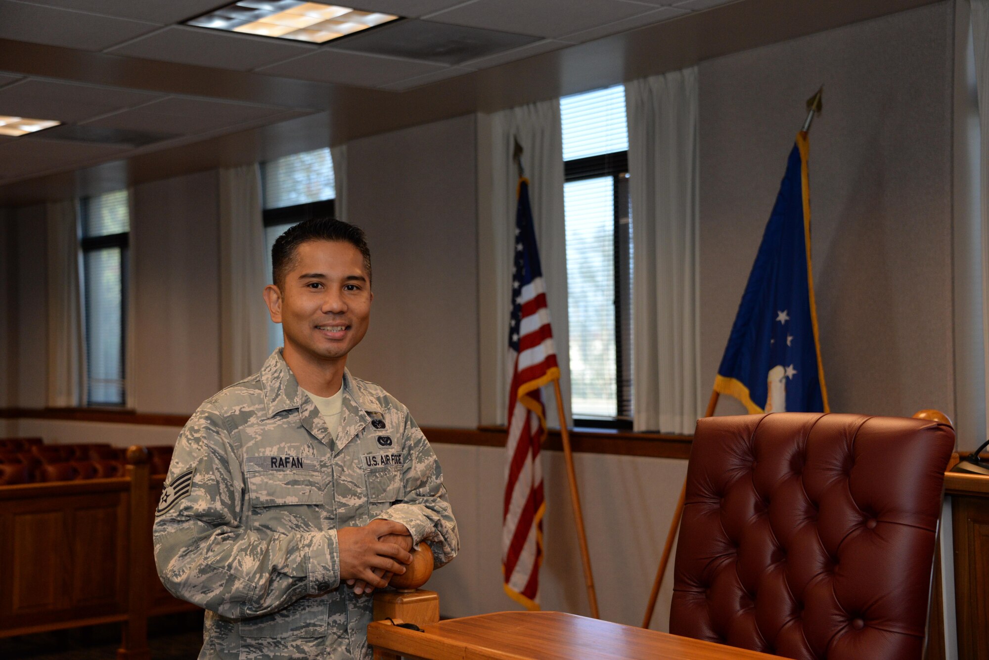 Staff Sgt. Chester Rafan,60th Air Mobility Wing military justice paralegal, poses for a photo Sept. 13 inside the courtroom at Travis Air Force Base, Calif. Rafan, as a paralegal, drafts Article 15s, prepares for courts martial and other cases on behalf of the United States Air Force. (U.S. Air Force photo by Senior Airman Amber Carter)