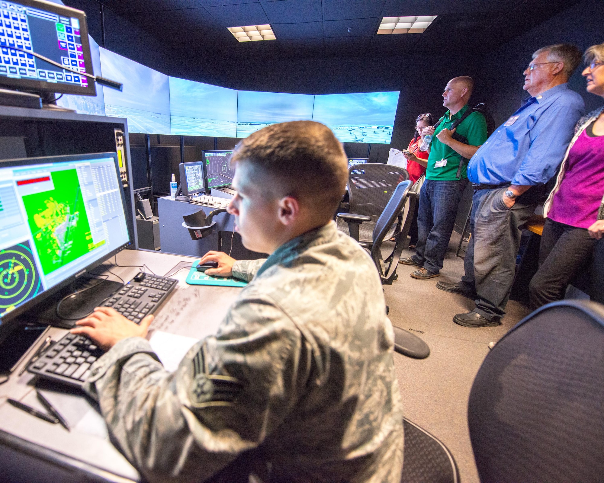 Honorary Commanders from Travis Air Force Base, Calif., receive a demonstration in the air traffic control tower simulator during the tour of the 60th Operations Group, Sep. 9, 2016. (U.S. Air Force photo by Louis Briscese)