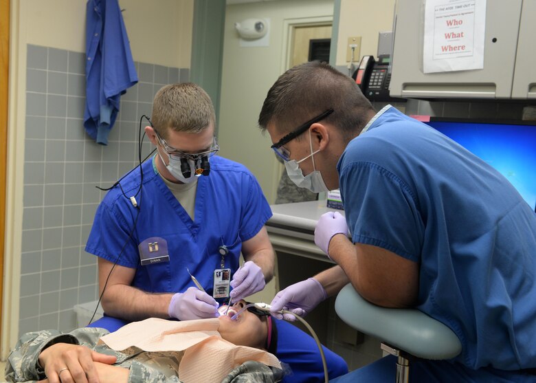 Capt. John Dinan (left), 9th Medical Group general dentist, performs dental work with Senior Airman Noah Jackson, prophy technician March 4, 2016, at Beale Air Force Base, California. The Beale Medical Group will be extending their clinic hours starting Oct. 1, 2016. The changes will expand access to healthcare and allow greater flexibility in scheduling visits. (U.S. Air Force photo/Senior Airman Ramon Adelan)