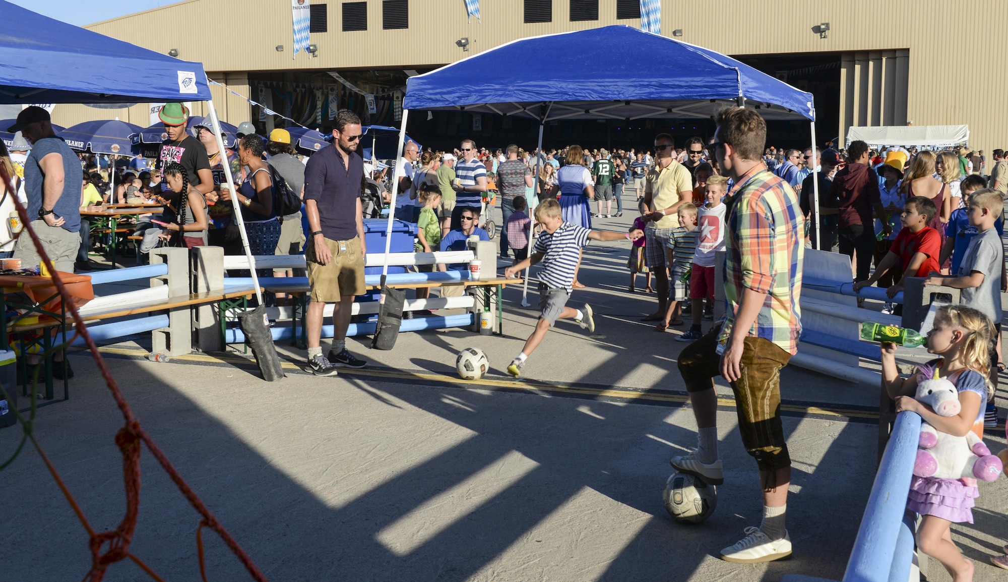 A young boy aims for a soccer net while participating in a game at the 20th annual Oktoberfest at Holloman Air Force Base, N.M. on Sept. 10, 2016. Germany’s Oktoberfest is the world’s largest beer fest and traveling funfair and is an important part of Bavarian culture. To fulfill the German tradition for German airmen currently stationed at Holloman, the German air force annually hosts its own Oktoberfest. (U.S. Air Force photo by Airman Alexis P. Docherty) 