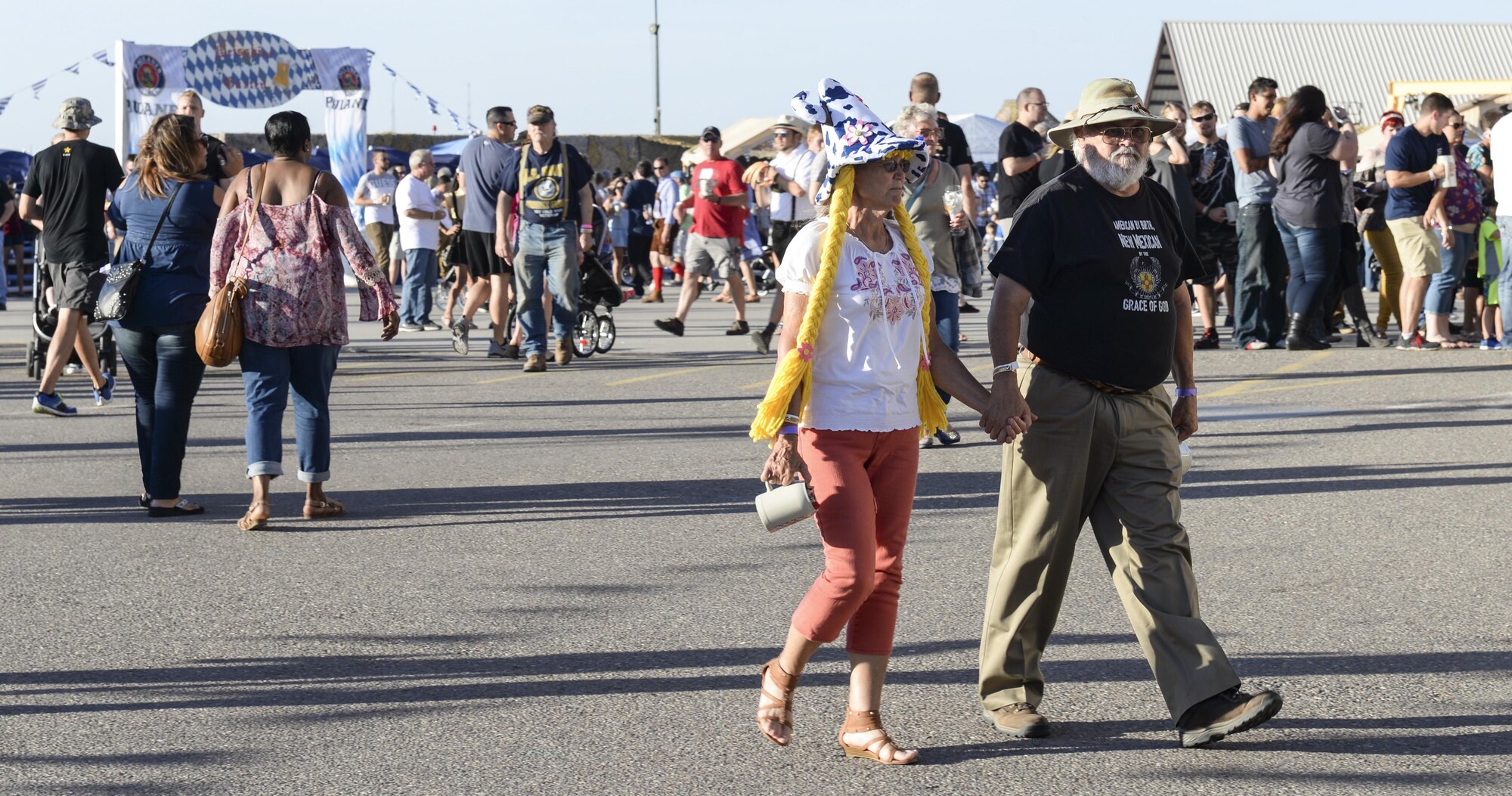 A couple take a stroll and enjoy the sites during the 20th annual Oktoberfest at Holloman Air Force Base, N.M. on Sept. 10, 2016. Thousands of Holloman Airmen and their families attended this year’s Oktoberfest. (U.S. Air Force photo by Airman Alexis P. Docherty) 
