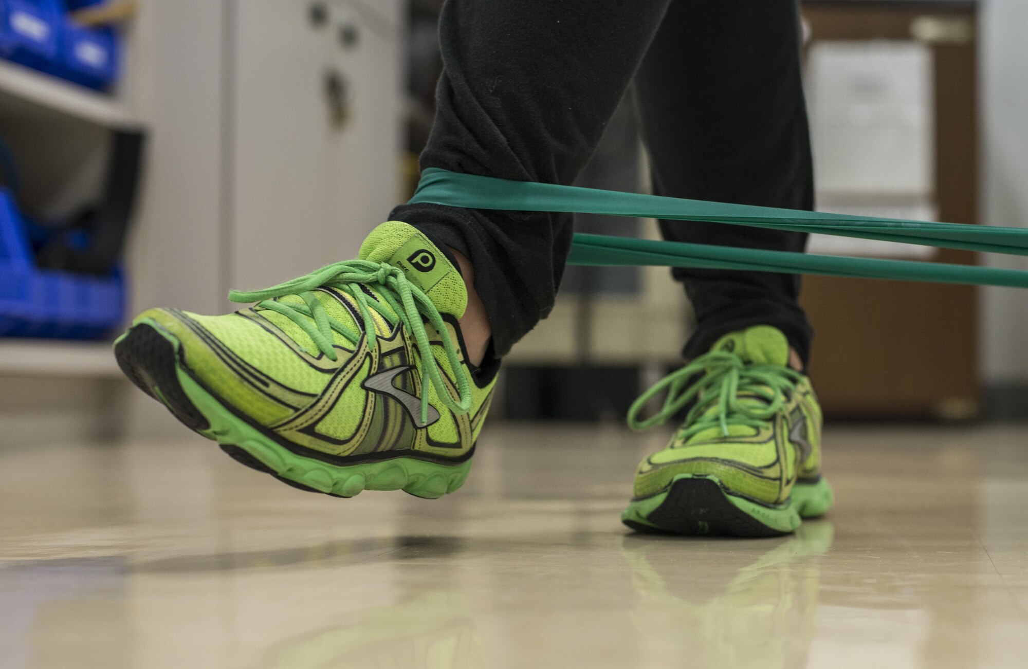U.S. Air Force Senior Airman Deana Heitzman, a public affairs photojournalist and physical therapy patient with the 35th Fighter Wing, uses a tension band at Misawa Air Base, Japan, Sept. 13, 2016. Heitzman suffered a Lisfranc injury requiring two surgeries as well as physical therapy. Physical therapy technicians help patients like Heitzman restore motor functions, improve mobility and relieve pain to help them heal and achieve overall wellness. (U.S. Air Force photo by Senior Airman Brittany A. Chase)