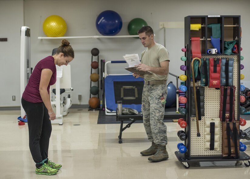 U.S. Air Force Senior Airman Deana Heitzman, a public affairs photojournalist and physical therapy patient with the 35th Fighter Wing, does band walks while Staff Sgt. Kelly Kofford, a physical therapy technician with the 35th Medical Operations Squadron, tracks her progress at Misawa Air Base, Japan, Sept. 13, 2016. Physical therapy technicians use a variety of equipment and exercises such as the anti-gravity treadmill and balancing exercises, in addition to therapeutic techniques like dry needling and foam rollers to alleviate pain and strengthen muscles and tendons. (U.S. Air Force photo by Senior Airman Brittany A. Chase)