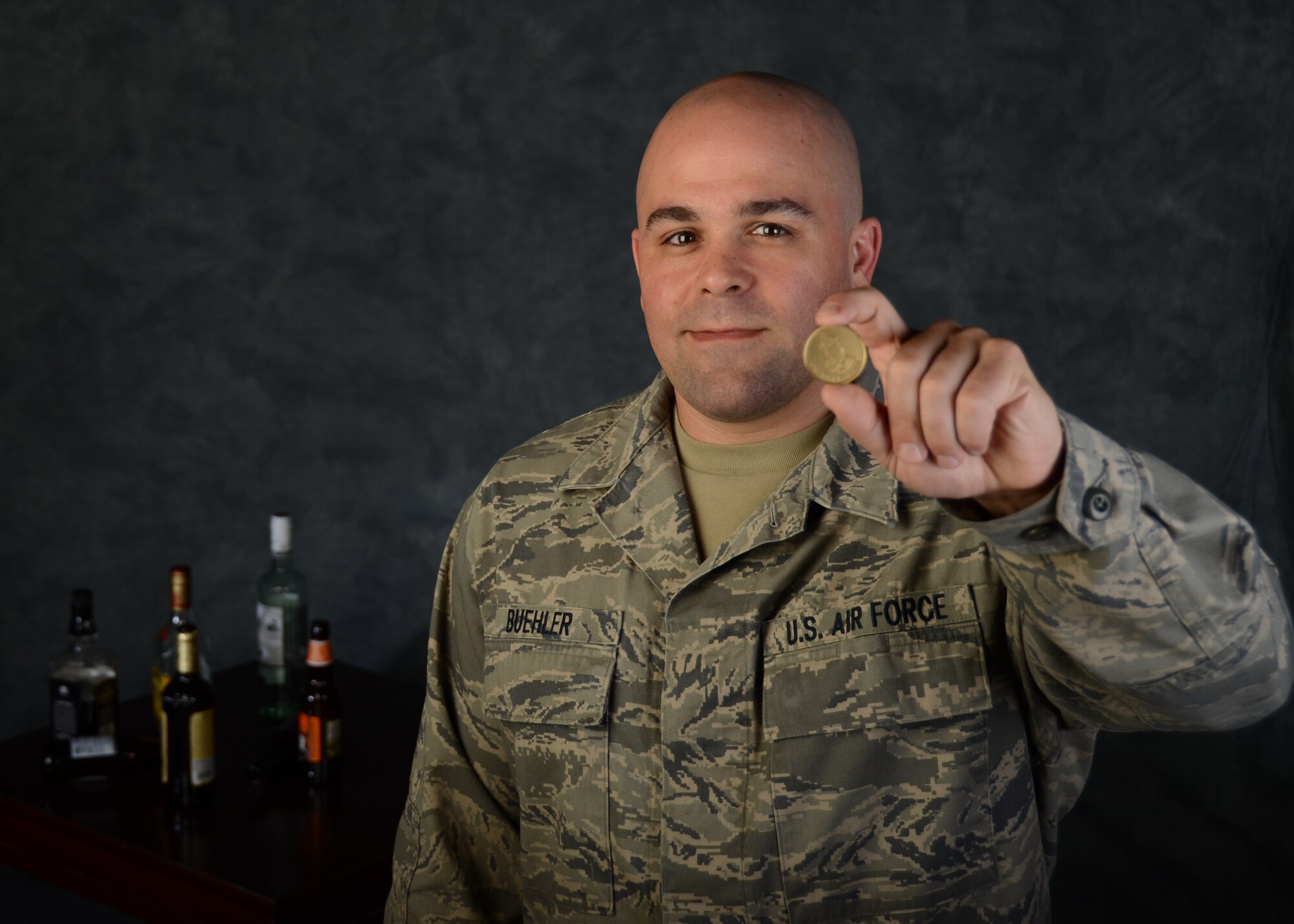 Tech. Sgt. Jeremy Buehler, maintainer with the 131st Bomb Wing at Whiteman Air Force Base, Missouri, holds his sobriety coin that reads One Day At A Time Apr. 8, 2016. Buehler demonstrates mental resilience as he has overcome alcoholism and depression by using psychological and mental health resources offered by the National Guard. Mental fitness is one of four pillars of Comprehensive Airman Fitness in AFI 90-506. Buehler credits his supervisors with saving his career. But, Buehler isn't the only one facing this issue. Suicide is one of the most urgent problems facing the Department of Defense and society. Among the reserves and National Guard, 88 Army, Navy, Air Force and Marine reservists died by suicide in 2015, while 100 Army National Guard members and 21 Air National Guardsmen killed themselves, according to a recent DoD report. The Guard has ongoing education and training programs, as well as psychological health professionals who help create a protective and resilient culture within the wings. (U.S. Air National Guard photo by Airman 1st Class Halley Burgess/RELEASED)