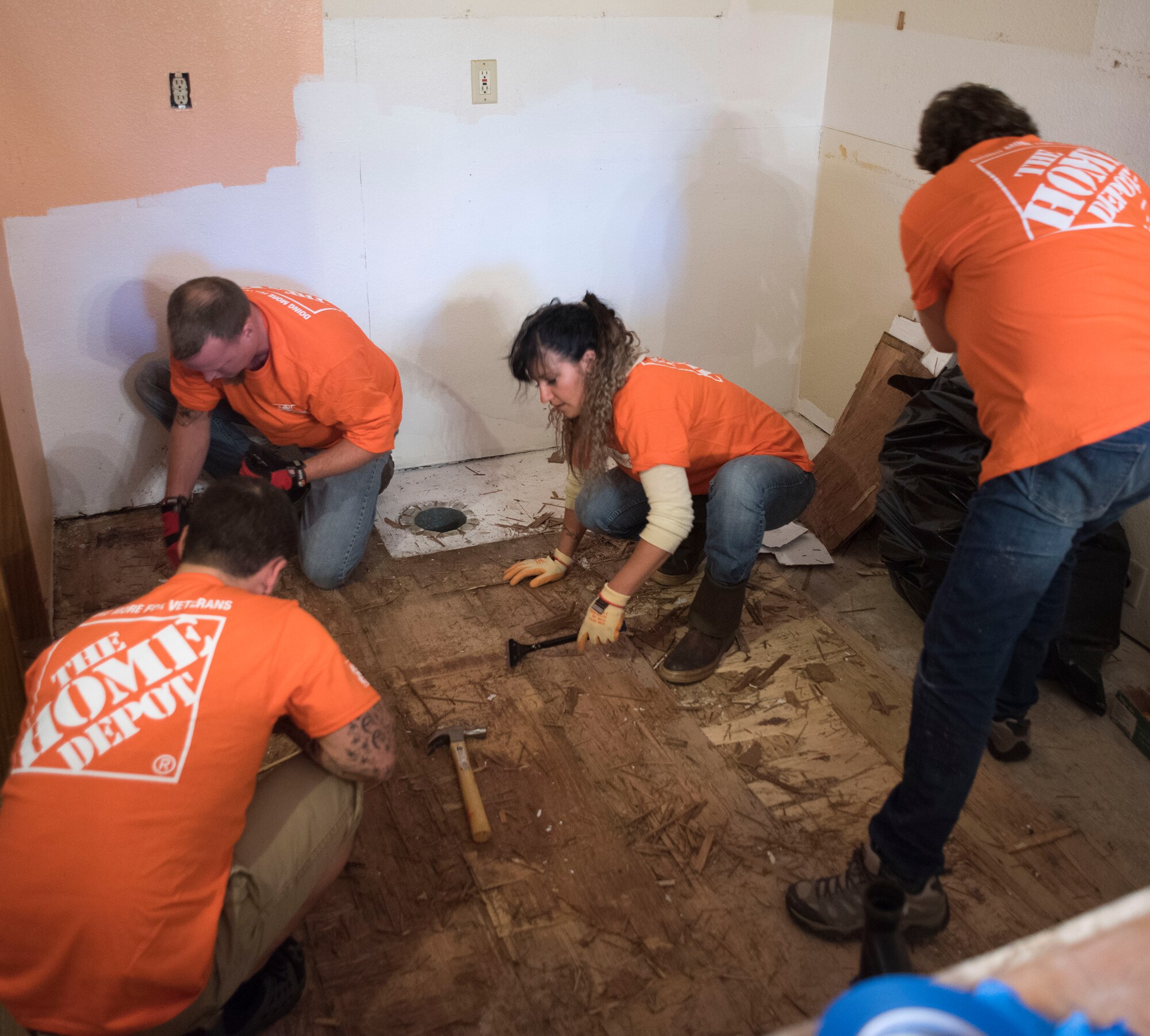 ANCHORAGE, Alaska -- Volunteers from the Alaska District of hardware chain Home Depot work together Sept. 14, 2016 to replace flooring in the kitchen of Staff Sgt. Sequoya Joseph, a personnelist with the Alaska Air National Guard's 176th Force Support Flight. The effort was the result of a partnership between Home Depot's annual Celebration of Service Campaign and the non-profit That Others May Live Foundation. National Guard photo by Maj. John Callahan.