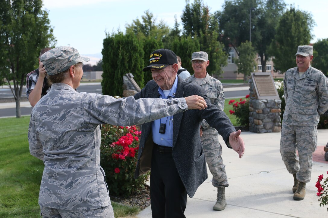 WWII Veteran Joe Rolison, moves to embrace 173rd Fighter Wing Vice Commander Col. Donna Prigmore during his visit to Kingsley Field in Klamath Falls, Oregon Aug. 31, 2016. They first met when Prigmore escorted Rolison and his wife, late Phyllis Kingsley Rolison—sister to the base's namesake  David R. Kingsley—on a trip to Bulgaria to honor Kingsley’s heroic sacrifice during the war and her presence here was a surprise to him. (U.S. Air National Guard photo by Tech. Sgt. Jefferson Thompson)