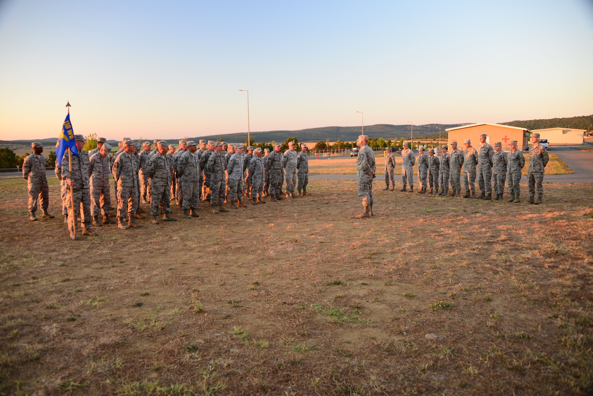 Airmen from the 118th Mission Support Group, Tennessee Air National Guard, stand at parade rest at a sunrise formation Aug. 15, 2016, while deployed to Novo Selo Training Area, Bulgaria.  Tennessee National Guard Soldiers and Airmen were on rotations to complete thier portions of projects as part of Operation Resolute Castle 16, an ongoing operation of military construction to build up Eastern European base infrastructure and help strengthen ties between Tennessee's state partnership with Bulgaria. (U.S. Air National Guard photo by Master Sgt. Kendra M. Owenby, 134 ARW Public Affairs)