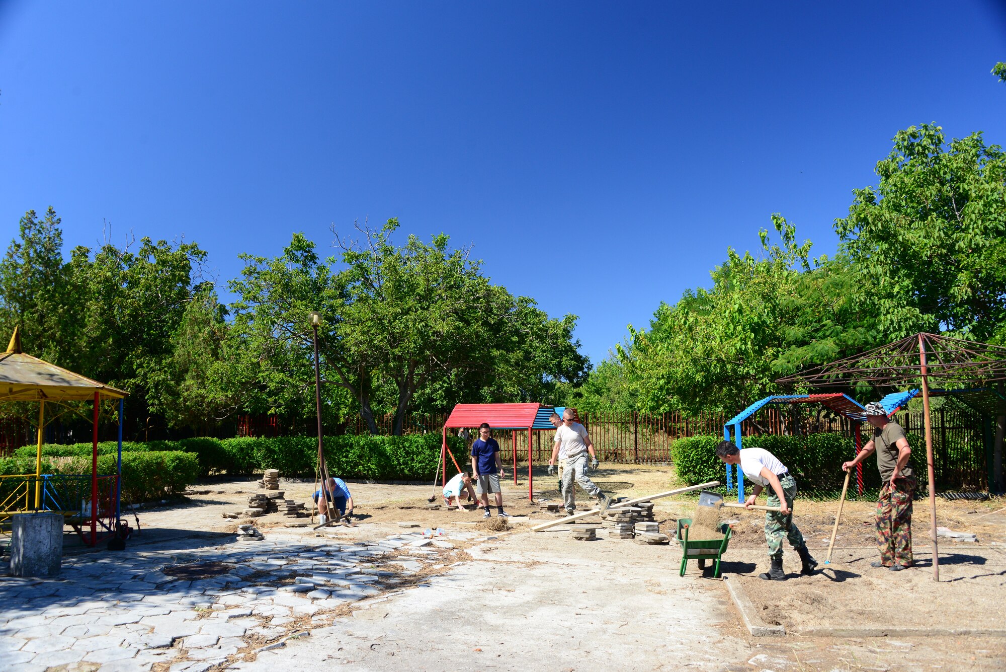 Members of the Tennessee National Guard and the Bulgarian Army work together to renovate the playground at the Izvorche Kindergarten School Aug. 15, 2016.  Tennessee National Guard Soldiers and Airmen from the 164th Civil Engineer Squadron, 118th Mission Support Group, 134th Air Refueling Wing, and the 194th Engineer Brigade deployed to Novo Selo Training Area, Bulgaria for thier annual training to participate in Humanitarian Civic Assistance projects such as the renovation.  The projects build skills for the Airmen while helping to strengthen ties with Tennessee and Bulgaria through the State Partnership Program.  (U.S. Air National Guard photo by Master Sgt. Kendra M. Owenby, 134 ARW Public Affairs)