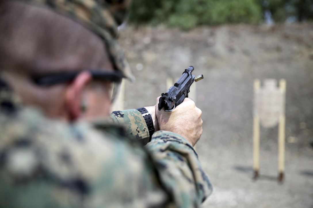 A Marine with Special Purpose Marine Air-Ground Task Force Crisis Response-Africa fires his M9 Beretta at a target during a live-fire range near Naval Air Station Sigonella, Italy, Sept. 10, 2016.  Marines with SPMAGTF-CR-AF took an advanced shooting course with Instructor Zero, a chief instructor with Spartan 360 Tactical Defense, who went over fundamentals and tactics of firing a handgun.  (U.S. Marine Corps photo by Cpl. Alexander Mitchell/released)
