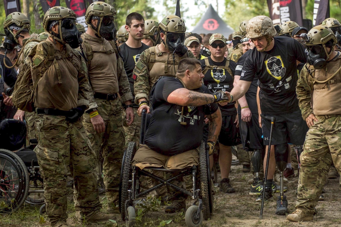 Members of Operation Enduring Warrior exchange greetings at the starting line of the Spartan Sprint Race at Fort Bragg, N.C., Sept. 10, 2016. Operation Enduring Warrior is a nonprofit made up of service members and veterans that supports wounded warriors. Air Force photo by Staff Sgt. Marianique Santos