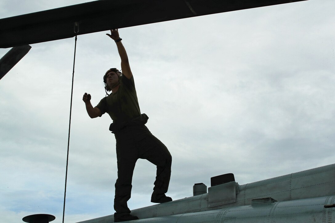 A Marine assigned to Marine Medium Tiltrotor Squadron 365 conducts a preflight check prior to takeoff en route to the USS Mesa Verde at Marine Corps Air Station New River, N.C., Sept. 14, 2016. Marine Corps photo by Lance Cpl. Brianna Gaudi